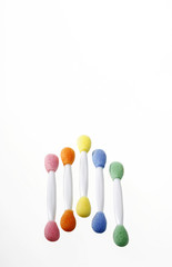 Five colourful applicators being arranged nicely