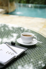 Cup of coffee, organizer and pen on a table