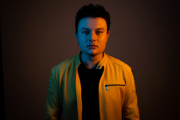 Young handsome man posing and playing guitar