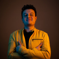 Young handsome man posing and playing guitar