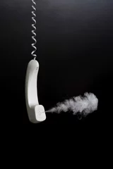 Fotobehang Smoke coming out from hanging telephone receiver © ImageHit
