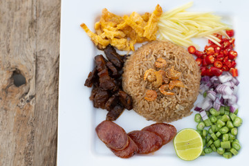 Thai food - Kao Cluk Ka Pi (Mixed Cooked Rice with Shrimp Paste Sauce) on white round dish. Fried rice with Shrimp paste, Thai style food. Thailand's national dishes. - obrazy, fototapety, plakaty