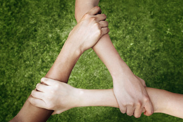 Children forming triangle by holding arms