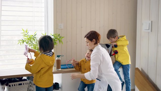 Mother with small children in hall in the morning at home, temper tantrum concept.