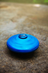 Blue top spinning on the ground