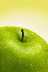 Close-up of a green apple with water droplets