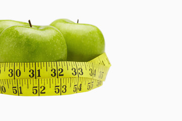 Measuring tape wound around three apples