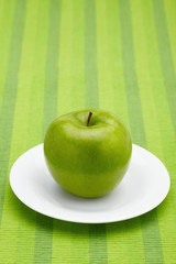 Green apple on a plate