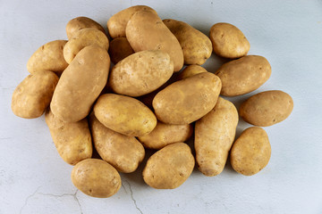 Raw organic potatoes on white background.