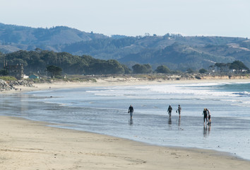 People enjoying being on the beautiful Half Moon Bay beach, California USA.