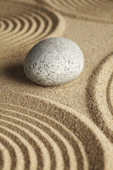 Fototapeta na wymiar Stone surrounded by rippled sand
