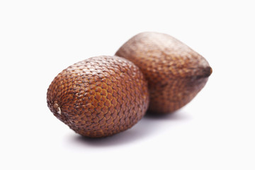 A pair of exotic snake fruit on white background