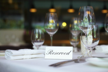 Restaurant table setting with reserved sign