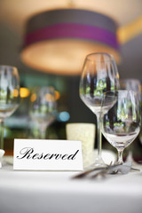 Restaurant table setting with reserved sign