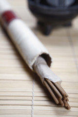 Joss sticks placed on a wooden mat