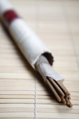 Joss sticks placed on a wooden mat