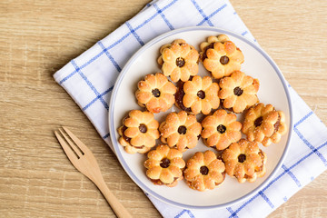 Cracker with pineapple jam (flower shape) on plate and fork, Thai snack	
