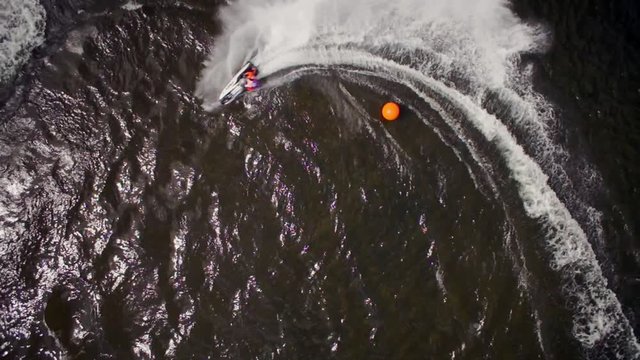 Aerial top down shot of Jet ski's making turns around a buoy of the race course