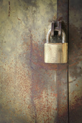 Padlock on rusty door