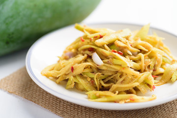 Thai food, Spicy green mango salad (Tum Ma Muang) on plate