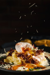 Fototapeta na wymiar italian cuisine food background of carbonara pasta fettucine with cream sauce and ham topping with poached egg and baked bacon and parmesan cheese, selective focused