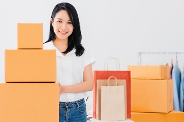 Asian beautiful empower woman working with online business shop at home.Owner businesswoman start up with Accept orders,Check number of products,Prepare to deliver products to customers.