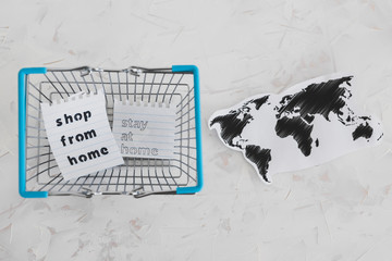 helping businesses after the global lockdown, shopping bags and world map with Shop from home and Stay Home message