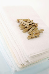 Wooden pegs on a stack of folded towels