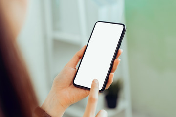 Closeup of young woman hand holding smartphone on the table and the screen is blank, social network concept..