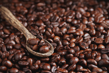 Roasted coffee beans and wooden spoon