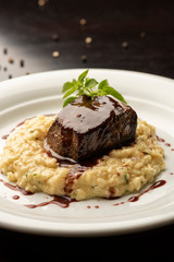 Fototapeta na wymiar steak sirloin tenderloin with wine sauce and risotto on plate