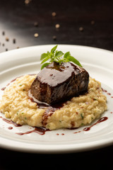 steak sirloin tenderloin with wine sauce and risotto on plate