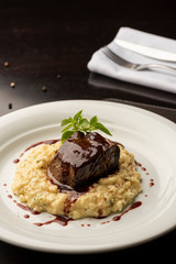 steak sirloin tenderloin with wine sauce and risotto on plate