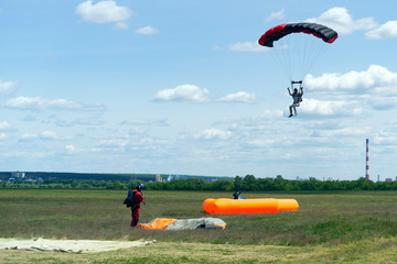 Kharkiv, Ukraine-May 26 2017: parachutists Landing on the ground soft air pallet, soft landing