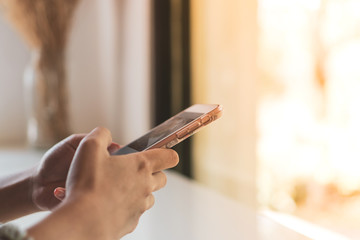 Woman hand use smartphone to do work business, social network, communication in public.