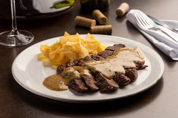 Steak with sauce with potato chips