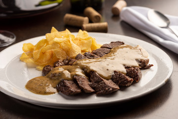 Steak with sauce with potato chips