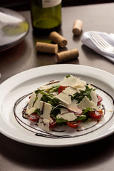 Arugula, rocket, tomatoes and parmesan salad dressed with balsamic vinegar
