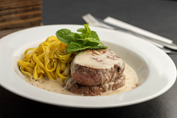 mussel on white plate fork and knife.