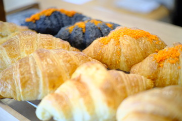 Fresh tasty croissants as background, closeup. French pastry 