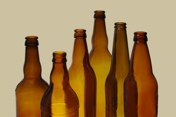 Six empty beer bottles. On a gray background.