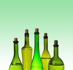 Five bottles with wine and drinks on a green background.