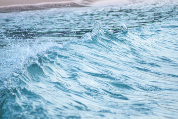 Sea wave splashing with panning effect blur and monochrome coloring