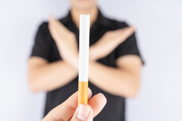 Young man refusing cigarette by lift his hand by crossing to show no smoking. World no tobacco day....