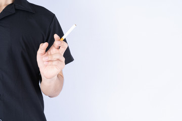 Man hold a cigarette with his hand. Stop smoking campaign. World no tobacco day.