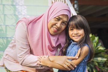 Grandmother and granddaughter hugging