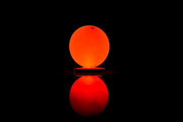 orange sphere on black background