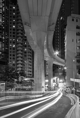Elevated road through residential building in Hong Kong city at night