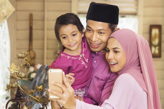 Malay Family Taking Self-photograph With A Smartphone