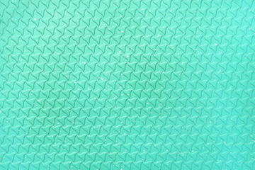 Bright abstract turquoise color background. The texture of the surface of the grill pan.